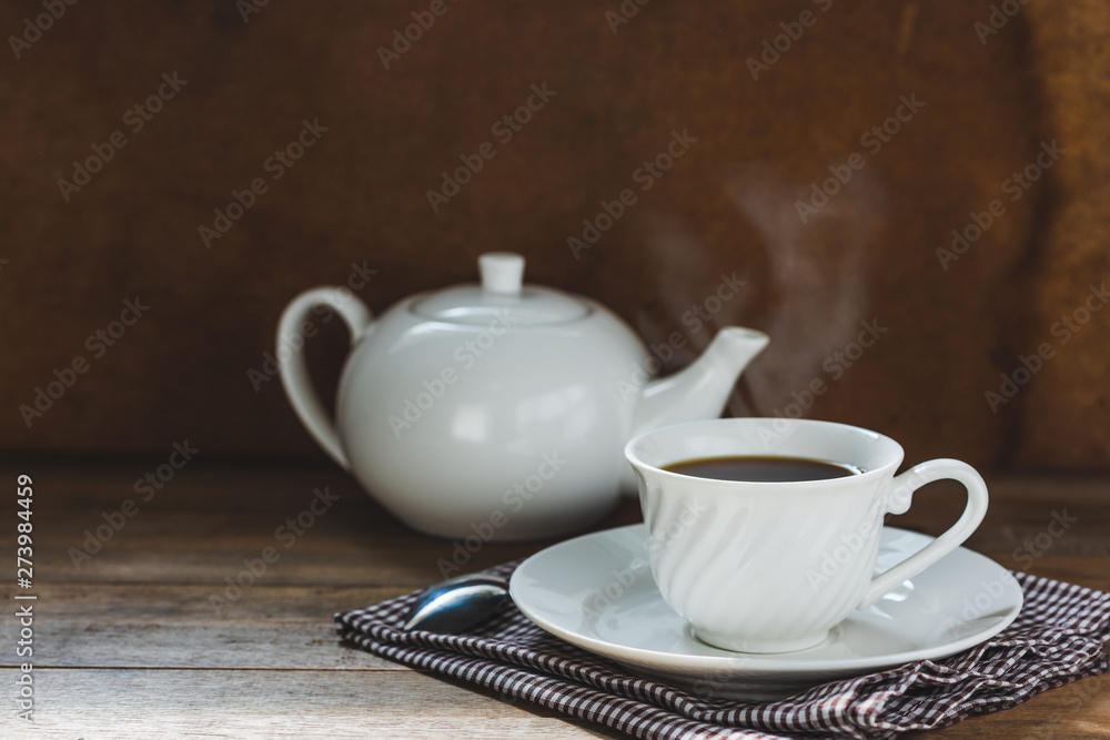 white tea set on wooden table, hot drink with steam white tea set on wooden table, hot drink with steam