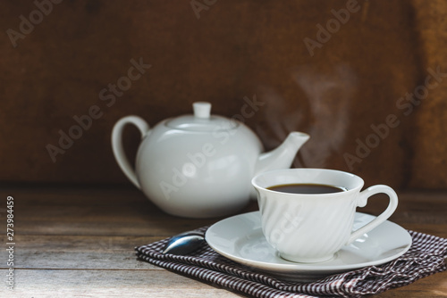 white tea set on wooden table, hot drink with steam