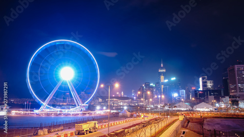 The Observation Wheel in Hong Kong island with a sharp and colourful city skyline at the background. © Freedom Fung