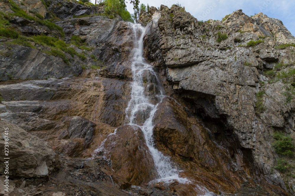 Obraz premium Waterfall in Altay mountains. Beautiful nature landscape. Popular touristic distination.