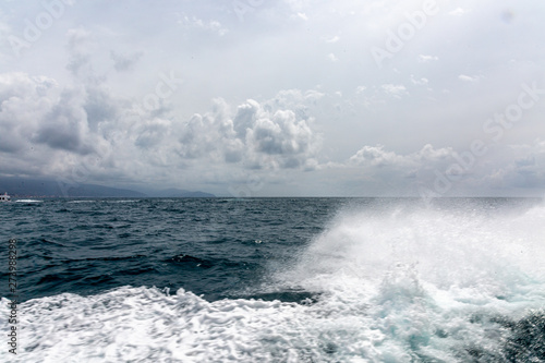 Waves  foam and sky from boat