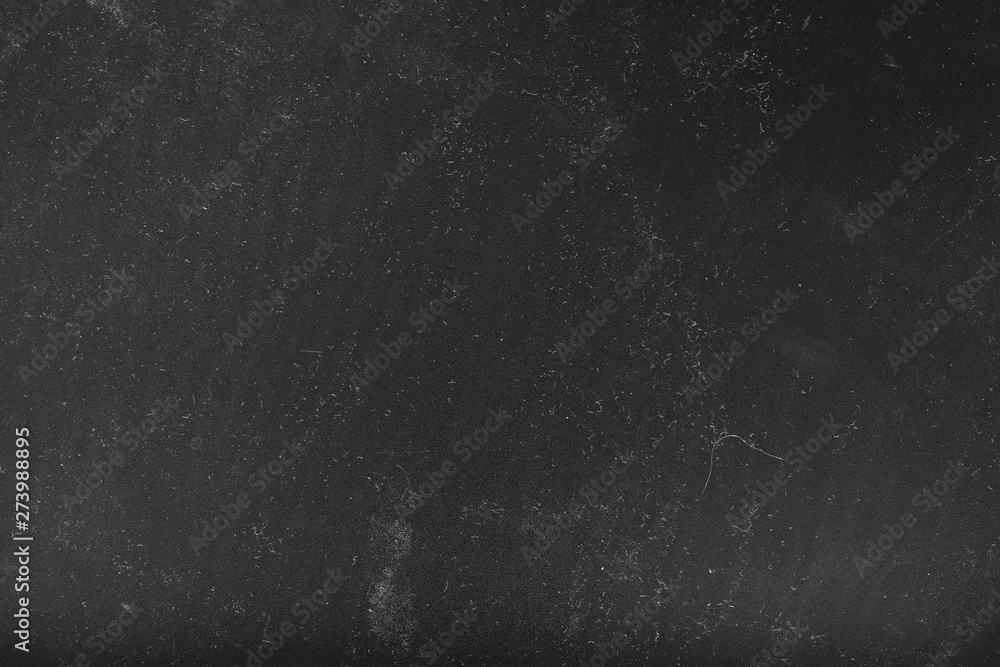 Sandpaper texture abstract background. White dust and scratches over black surface. Empty space.