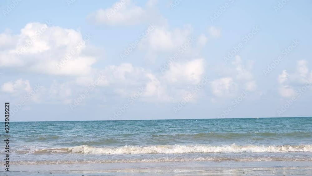 Blue sky with white clouds over the calm sea with white waves in the summer. Blue sky with white clouds over the calm sea with white waves in the summer.