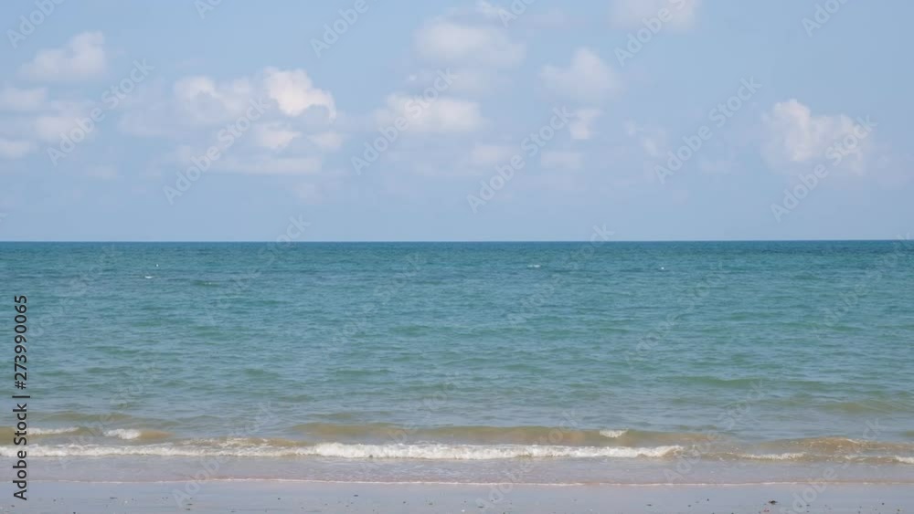 lue sky with white clouds over the calm sea with white waves in the summer. lue sky with white clouds over the calm sea with white waves in the summer.
