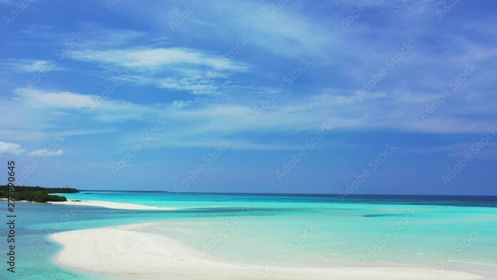 Aerial view of white sandbanks in front of a tropical island. In the turquoise Caribbean Sea under a dramatic blue sky. Dolly out. Aerial view of white sandbanks in front of a tropical island. In the turquoise Caribbean Sea under a dramatic blue sky. Dolly out.