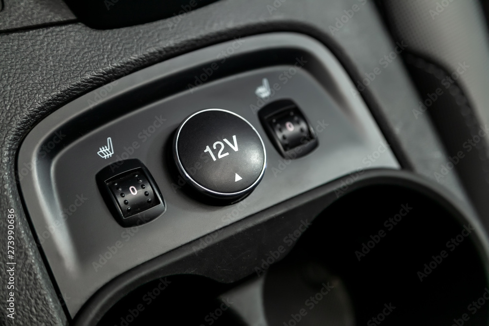  Close-up on the seat heatting buttons,    charging . modern car interior: parts, buttons, knobs..