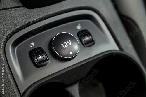  Close-up on the seat heatting buttons, charging . modern car interior: parts, buttons, knobs..