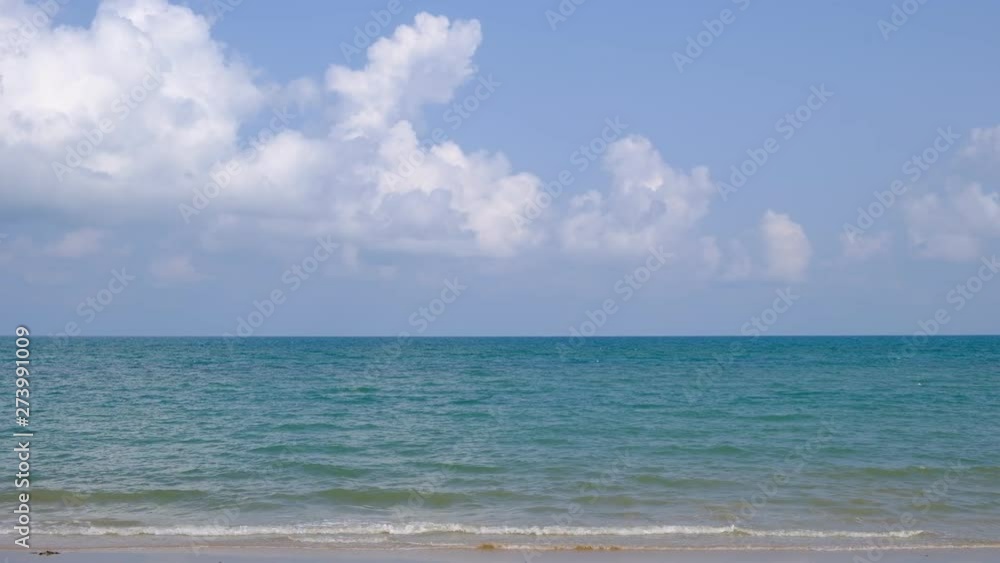 lue sky with white clouds over the calm sea with white waves in the summer. lue sky with white clouds over the calm sea with white waves in the summer.