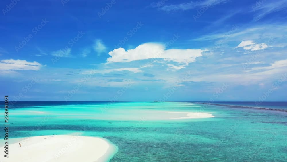 Slow dolly in, flying above sand banks in the turquoise water of the Maldives Sea. A dramatic sky, reefs at the right. Slow dolly in, flying above sand banks in the turquoise water of the Maldives Sea. A dramatic sky, reefs at the right.