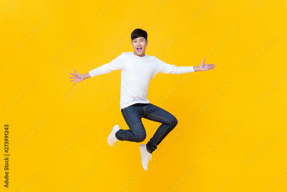 Young happy Korean teen jumping welcomely