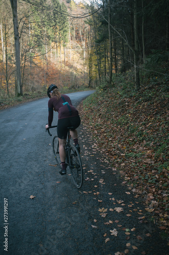 Autumn bike ride with climbing up in the valley covered with golden leaves © Pavel