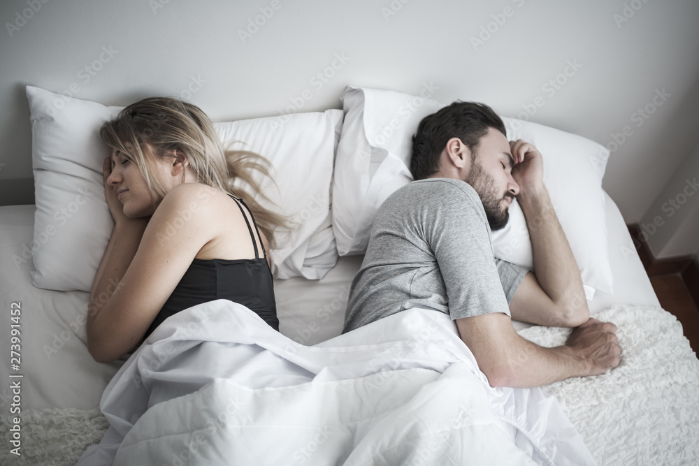 couple sleeping in bed, ignoring each other avoiding sex, having conflict or sexual problems concept couple sleeping in bed, ignoring each other avoiding sex, having conflict or sexual problems concept