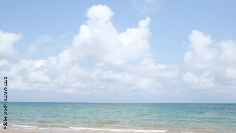 lue sky with white clouds over the calm sea with white waves in the summer. lue sky with white clouds over the calm sea with white waves in the summer.