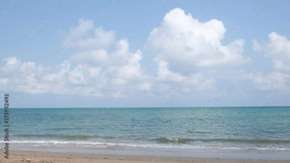 lue sky with white clouds over the calm sea with white waves in the summer. lue sky with white clouds over the calm sea with white waves in the summer.