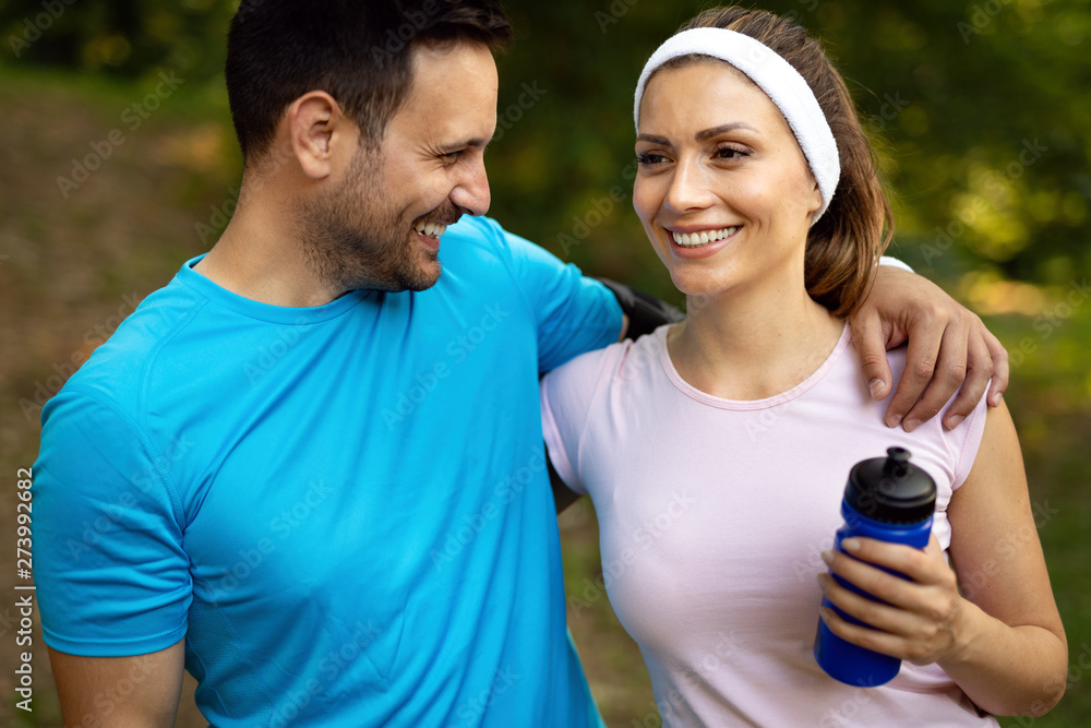 Young people running outdoors. Couple or friends of runners exercising in park Young people running outdoors. Couple or friends of runners exercising in park