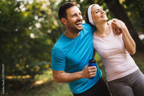 Exhausted fit couple runners after fitness running workout outdoors