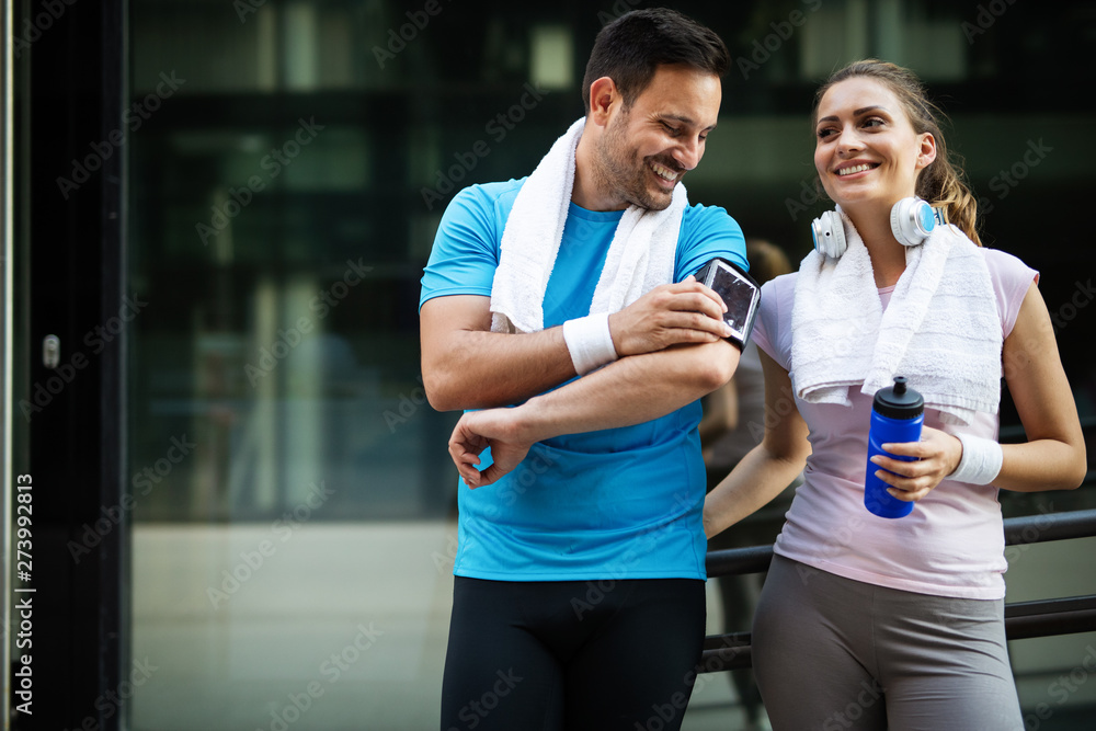 Sporty happy couple exercising together. Sport concept - obrazy, fototapety, plakaty 