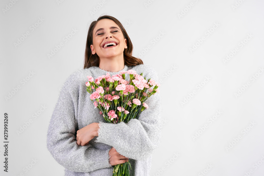 Joyful woman with bunch of pink cloves Joyful woman with bunch of pink cloves