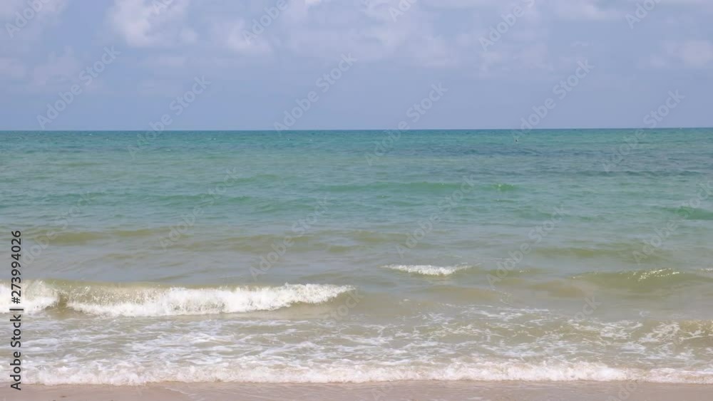 lue sky with white clouds over the calm sea with white waves in the summer. lue sky with white clouds over the calm sea with white waves in the summer.