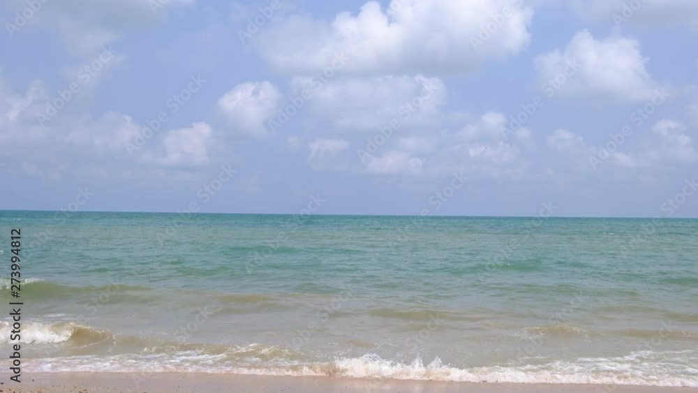 Blue sky with white clouds over the calm sea with white waves in the summer. Blue sky with white clouds over the calm sea with white waves in the summer.