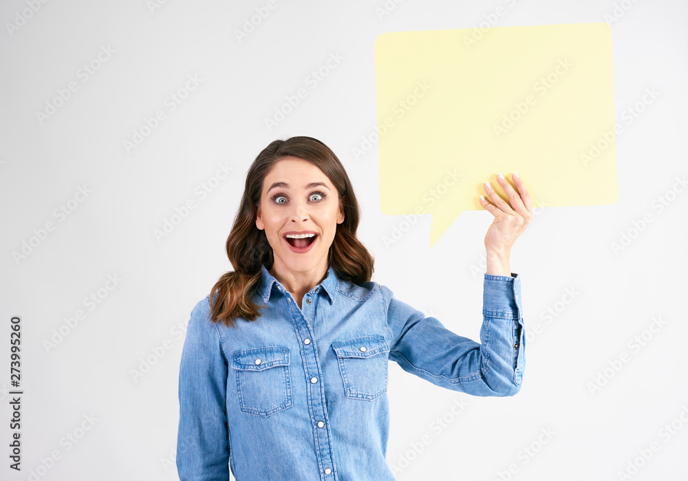 Surprised woman with speech bubble in studio shot Surprised woman with speech bubble in studio shot