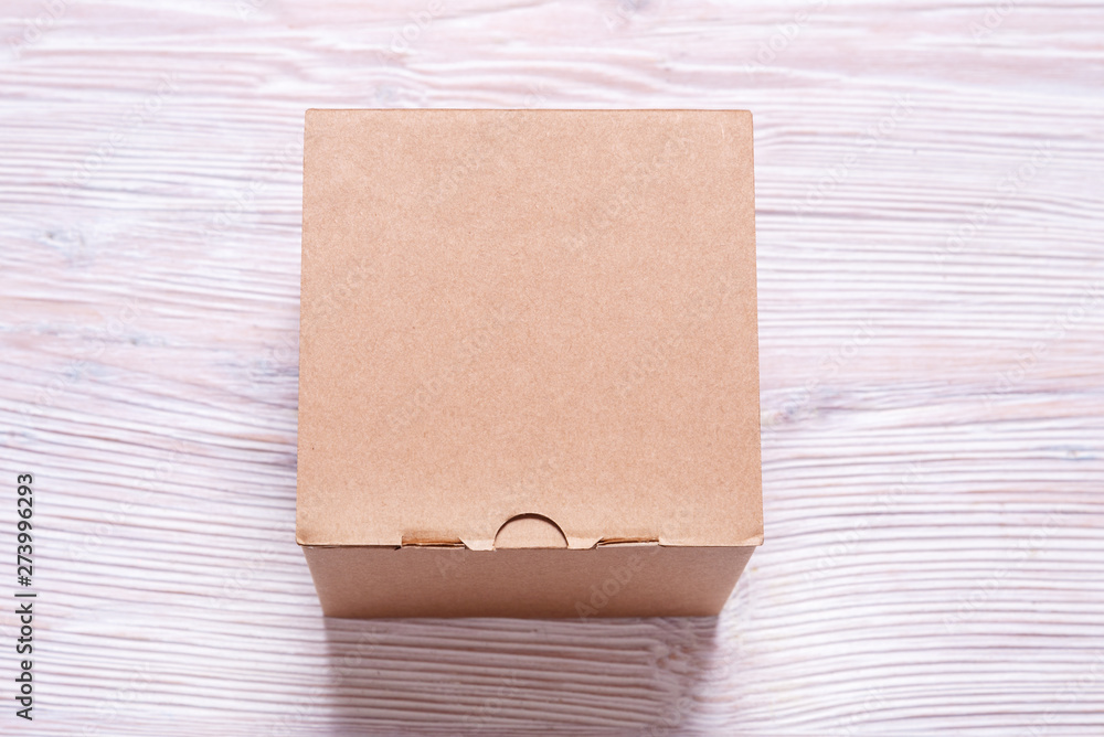 Fototapeta premium Cardboard box on wooden background