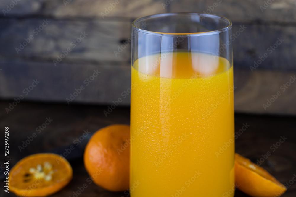 Fresh healthy orange juice, smoothie in a glass on wooden background. summer concept. Fresh healthy orange juice, smoothie in a glass on wooden background. summer concept.