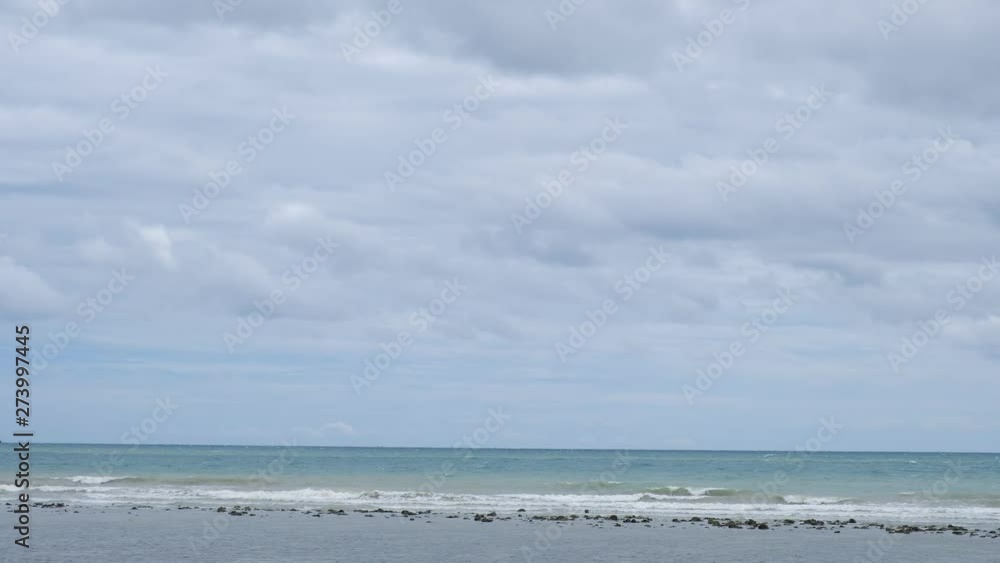lue sky with white clouds over the calm sea with white waves in the summer. lue sky with white clouds over the calm sea with white waves in the summer.