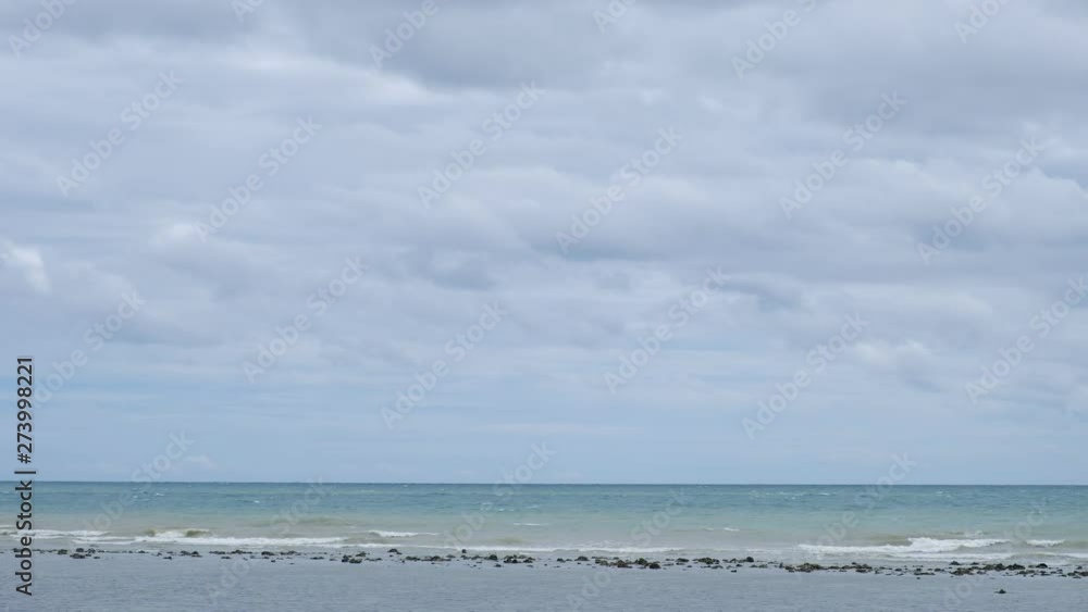 Blue sky with white clouds over the calm sea with white waves in the summer. Blue sky with white clouds over the calm sea with white waves in the summer.
