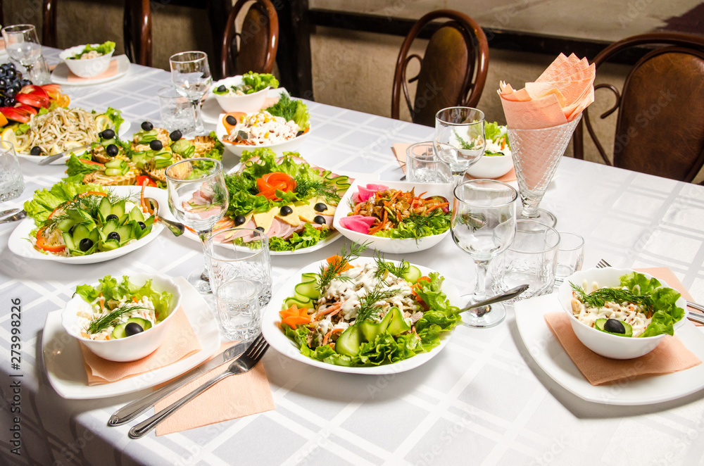 table lined with variety of dishes from which the centerpiece is dish with banquet cutting with ham and dish with several tartlets with chicken and ham table lined with variety of dishes from which the centerpiece is dish with banquet cutting with ham and dish with several tartlets with chicken and ham