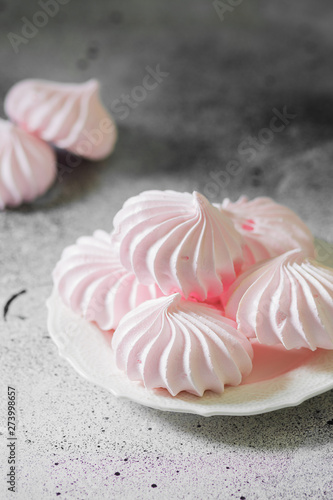 Pink meringue. French dessert. On the grey table