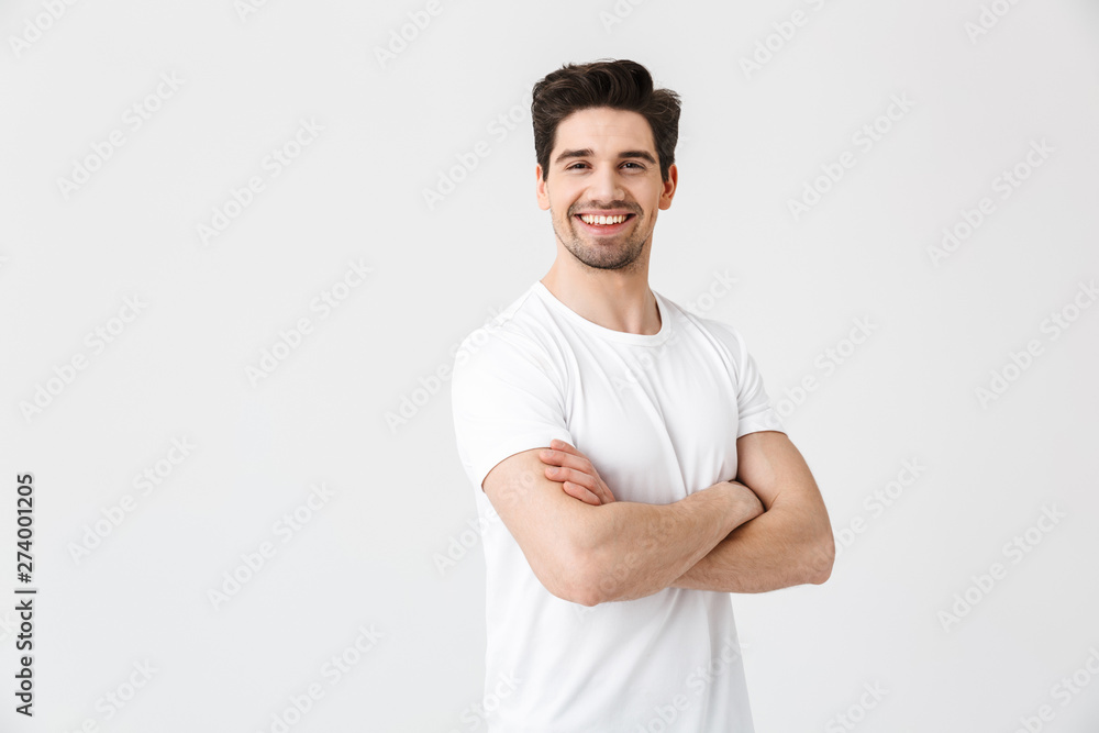 Happy young excited emotional man posing isolated over white wall background. - obrazy, fototapety, plakaty 