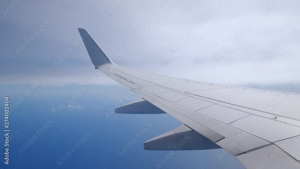 Plane Wing passing through clouds Plane Wing passing through clouds