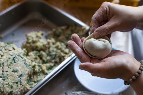 Woman is making dumplings. Making of Korean mandu. photo