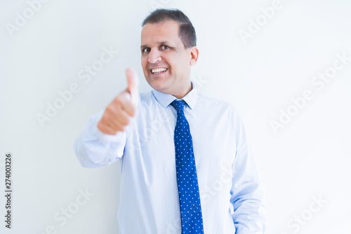 Middle age man doing postive gesture with thumbs up smiling to the camera