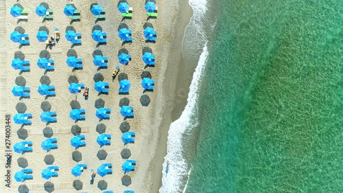 Aerial: sea coast, sandy beach, sun umbrellas, sea resort, Europe. photo