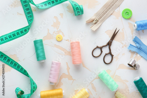 Set of sewing threads and accessories on light background