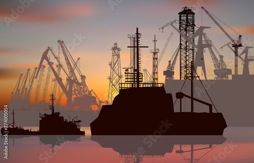 ships and cranes in seaport at sunrise