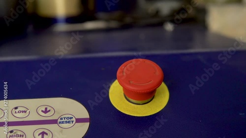 Pressing the red emergency button on the panel