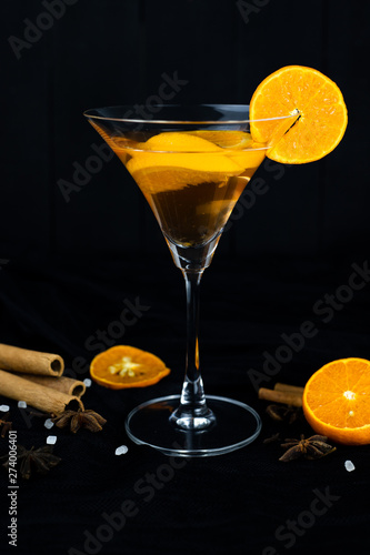 orange cocktail, Christmas hot drink in glass with orange, cinnamon, star anise, Clove.