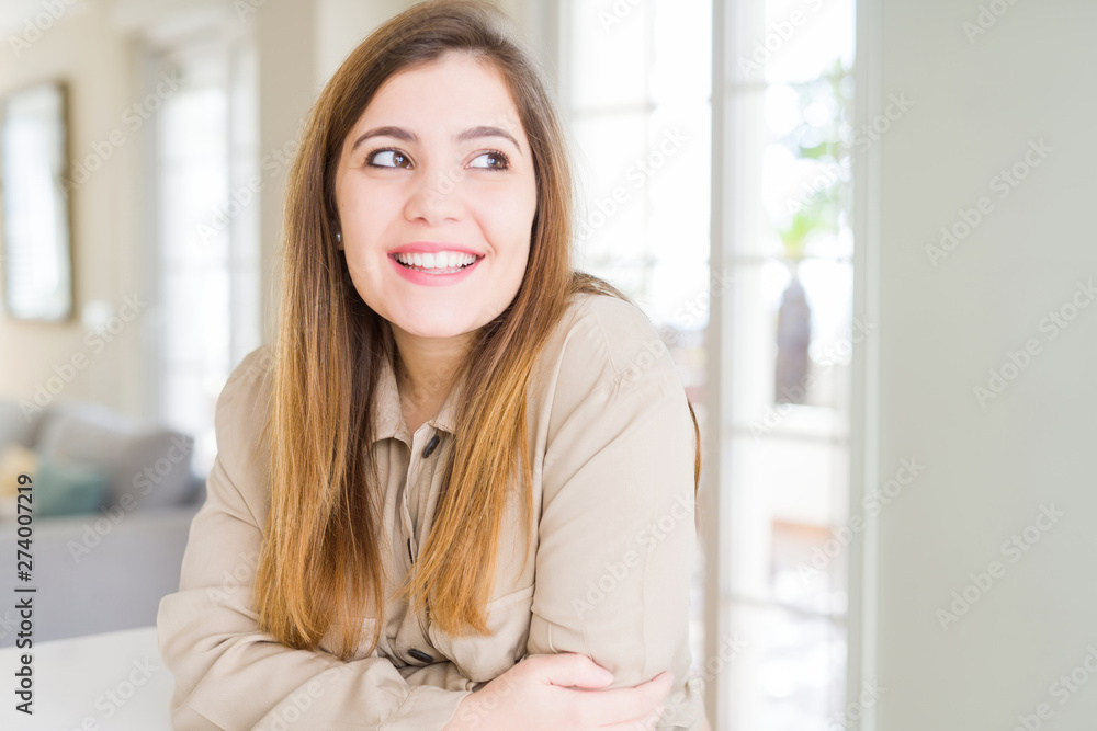 Beautiful young woman at home smiling looking side and staring away thinking. Beautiful young woman at home smiling looking side and staring away thinking.