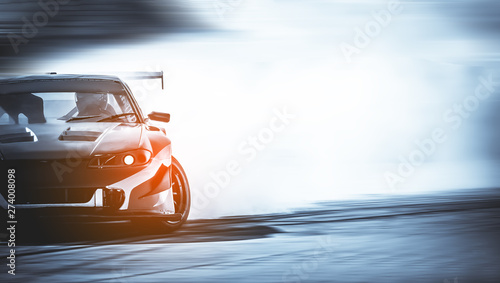 Car drifting, Blurred of image diffusion race drift car with lots of smoke from burning tires on speed track