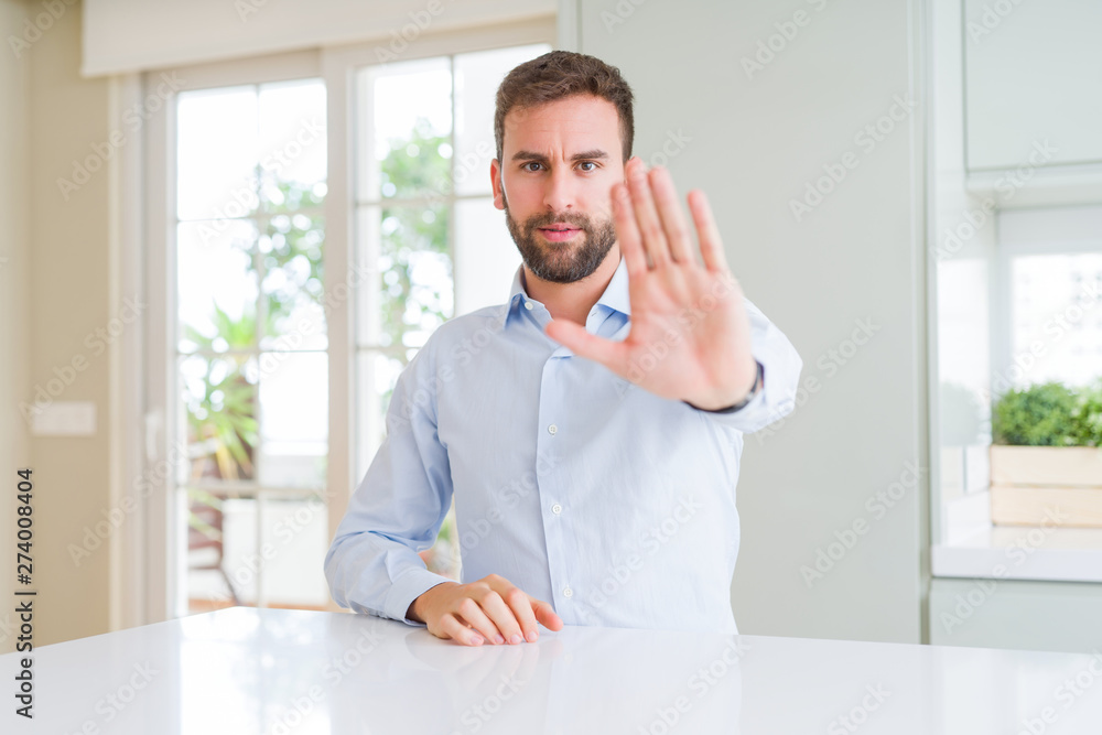 Handsome business man doing stop sing with palm of the hand. Warning expression with negative and serious gesture on the face. Handsome business man doing stop sing with palm of the hand. Warning expression with negative and serious gesture on the face.