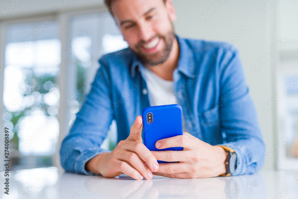 Close up of man hands using smartphone and smiling Close up of man hands using smartphone and smiling