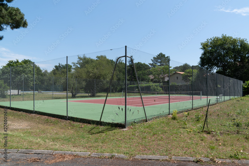 Empty synthetic outdoor green red tennis court