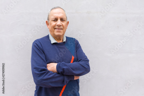 Handsome middle age senior man smiling cheerful, happy and positive leaning over white background with crossed arms photo