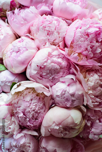 peonies in a bouquet of flowers on a leg in the interior of the restaurant for a celebration shop floristry wedding salon
