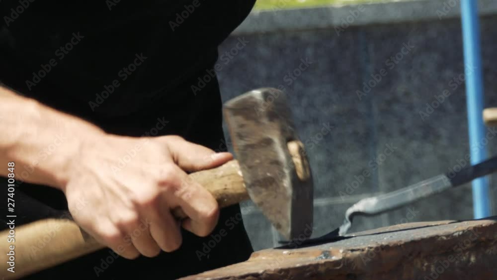 Blacksmith manufactures sheet metal plant. Hammer. Forge. Close-up. Hot metal. Iron. Blacksmith manufactures sheet metal plant. Hammer. Forge. Close-up. Hot metal. Iron.
