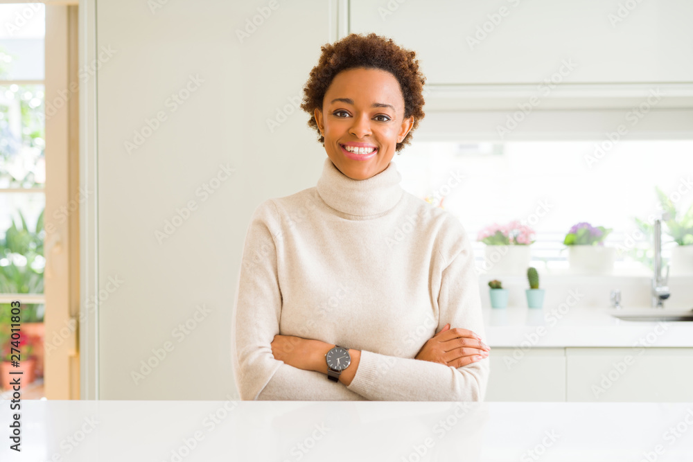 Young beautiful african american woman at home happy face smiling with crossed arms looking at the camera. Positive person. Young beautiful african american woman at home happy face smiling with crossed arms looking at the camera. Positive person.