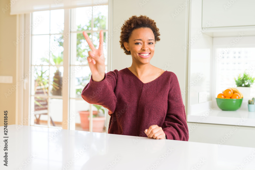 Young beautiful african american woman at home smiling looking to the camera showing fingers doing victory sign. Number two. Young beautiful african american woman at home smiling looking to the camera showing fingers doing victory sign. Number two.